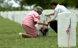 Mourners often pray at gravesides of loved ones.